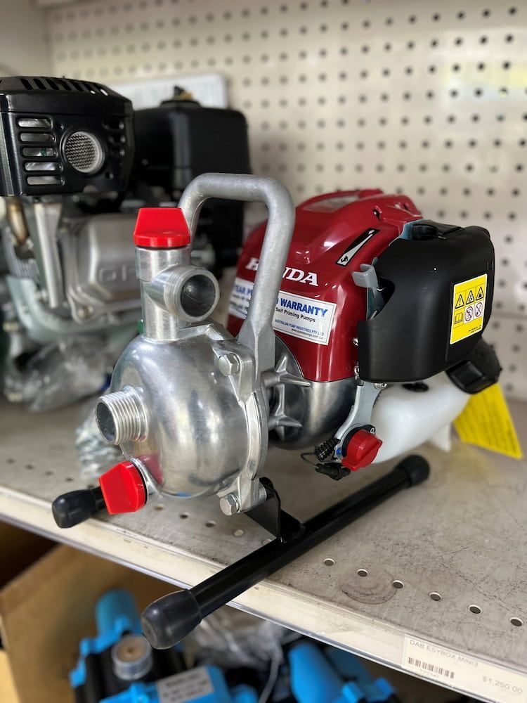 Red and Silver Water Pump With Black Engine on Shelf — Gloucester Rural Supplies in Stroud, NSW