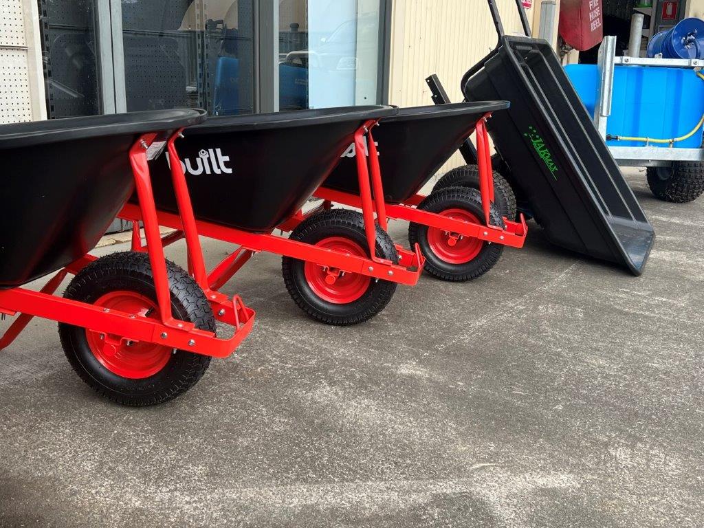 A Row of Wheelbarrows With Red Wheels Are Parked — Gloucester Rural Supplies in Gloucester, NSW