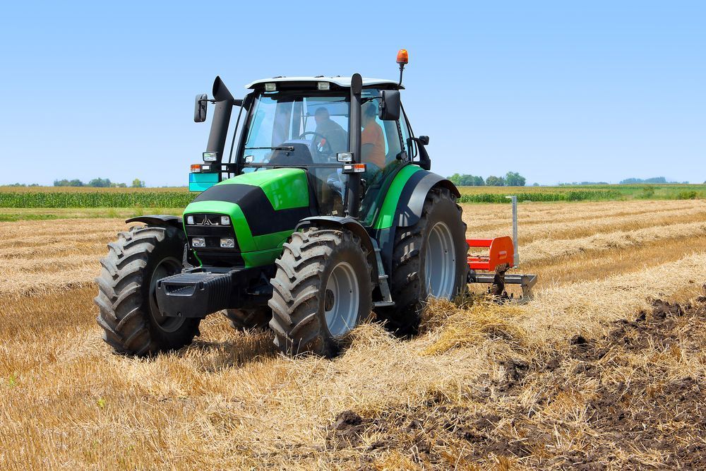 Tractor On The Farmland — Gloucester Rural Supplies in Bulahdelah, NSW