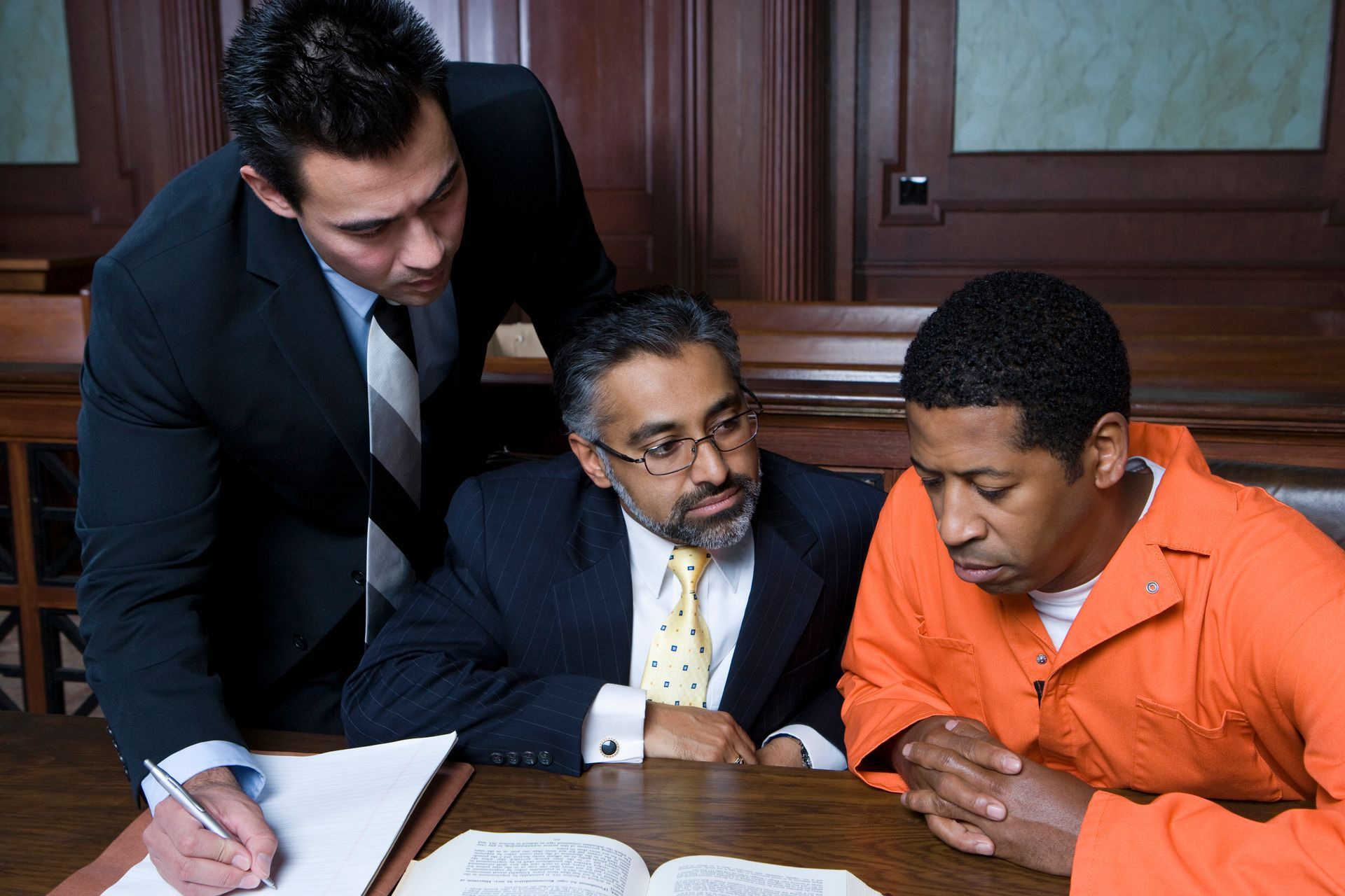 Legal team offering strategic criminal defense representation for a client in court. 