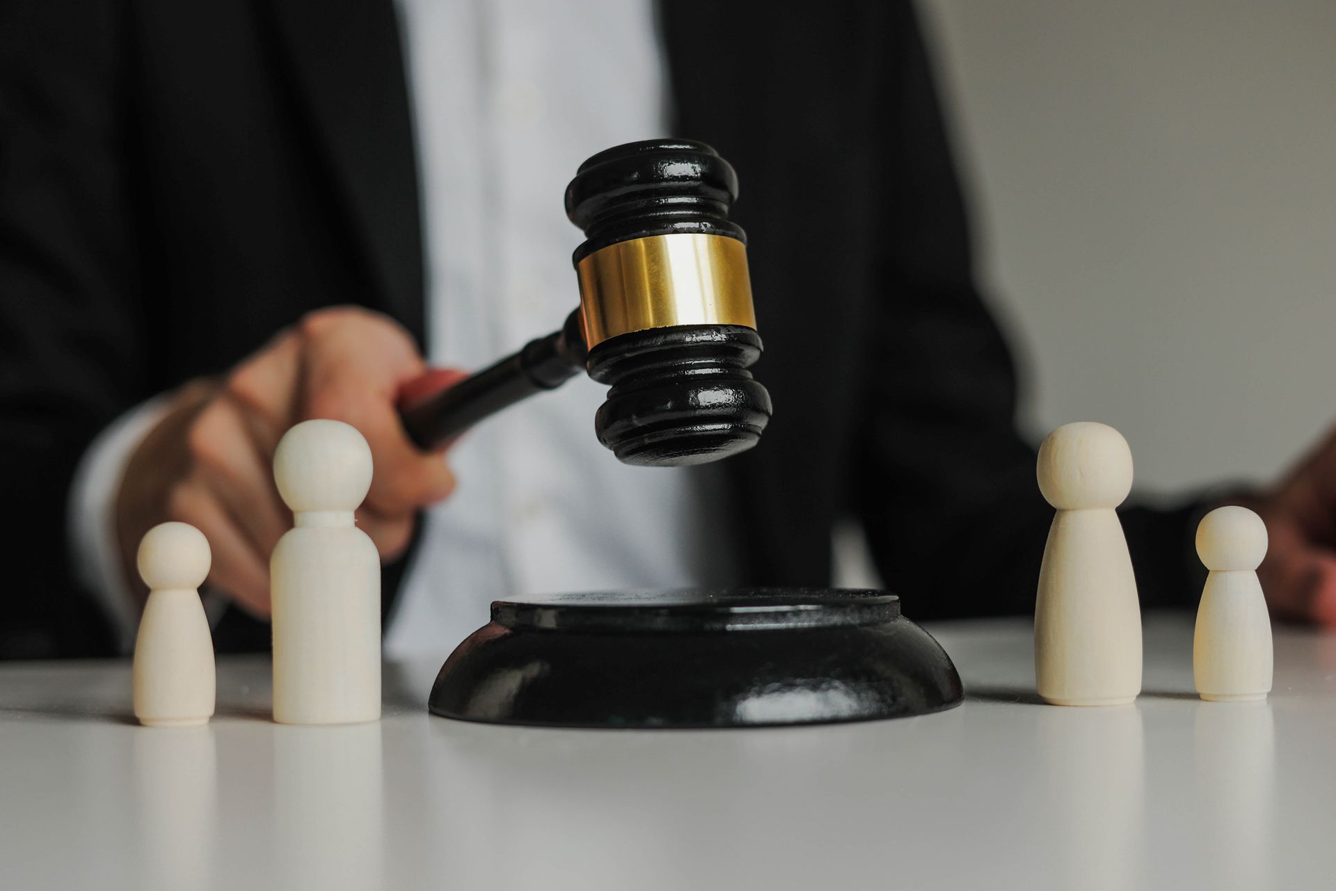 Figures of family are separated by judge's gavel.