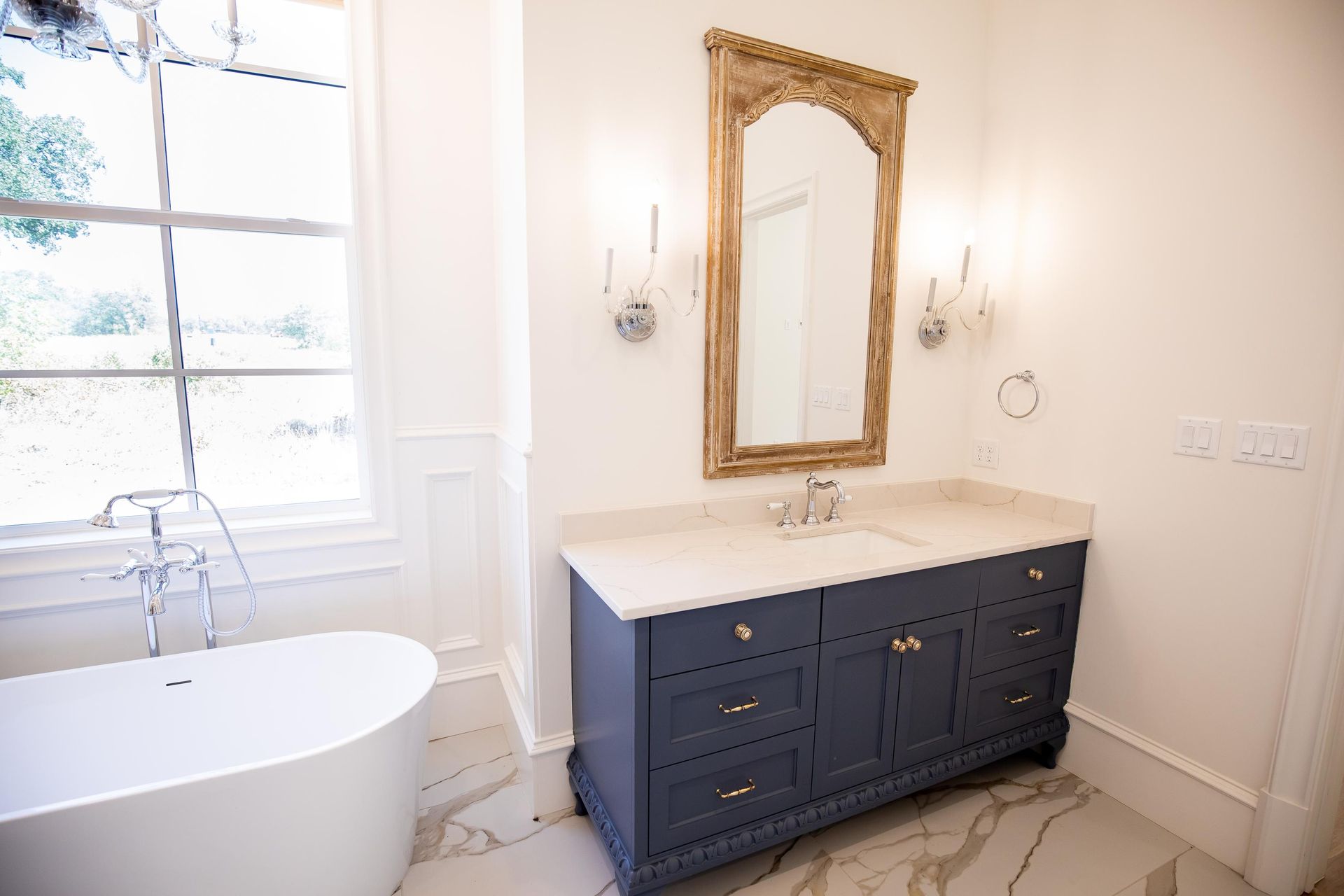 A bathroom with two sinks and a window.