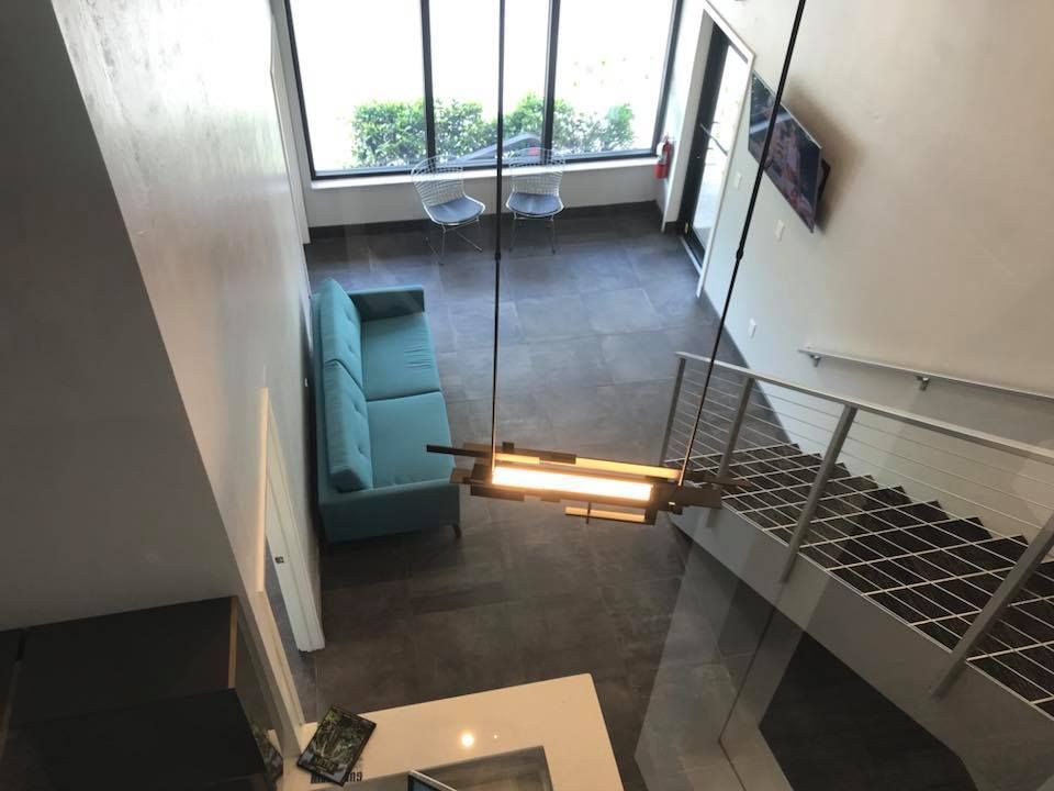 An aerial view of a living room with a couch and stairs