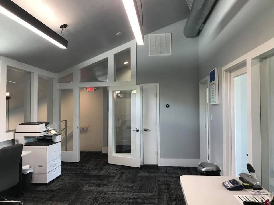 A room with a desk and a printer in it