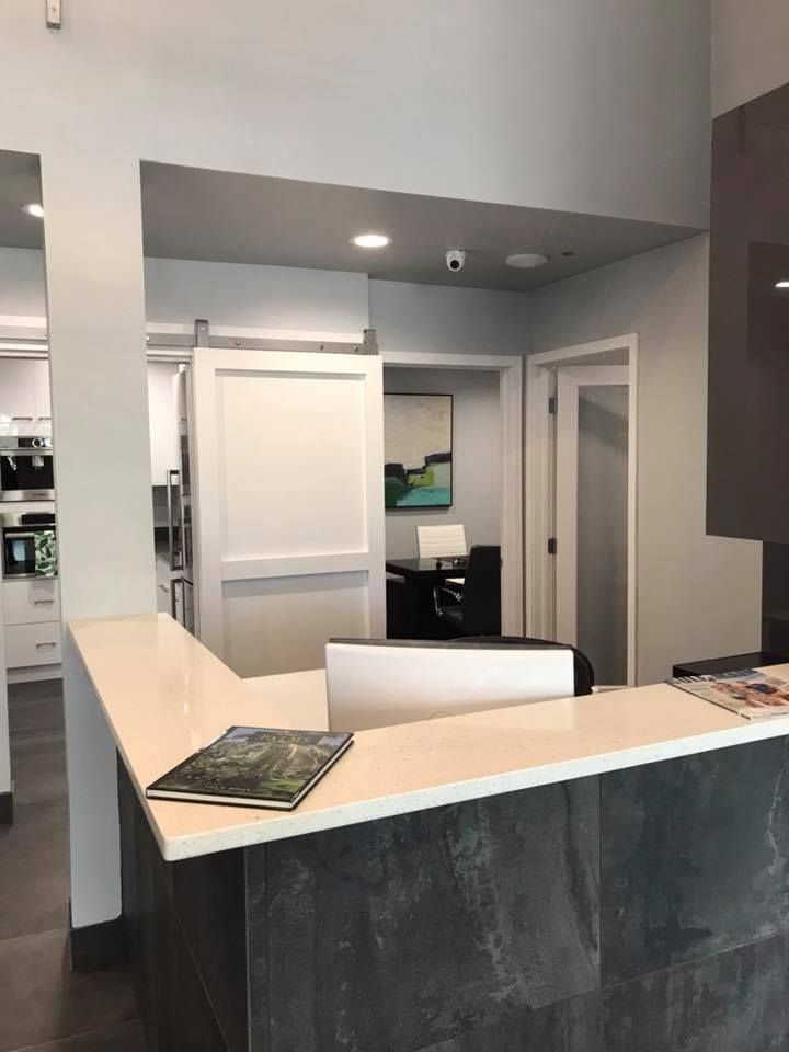 A reception desk with a computer on it in a room.