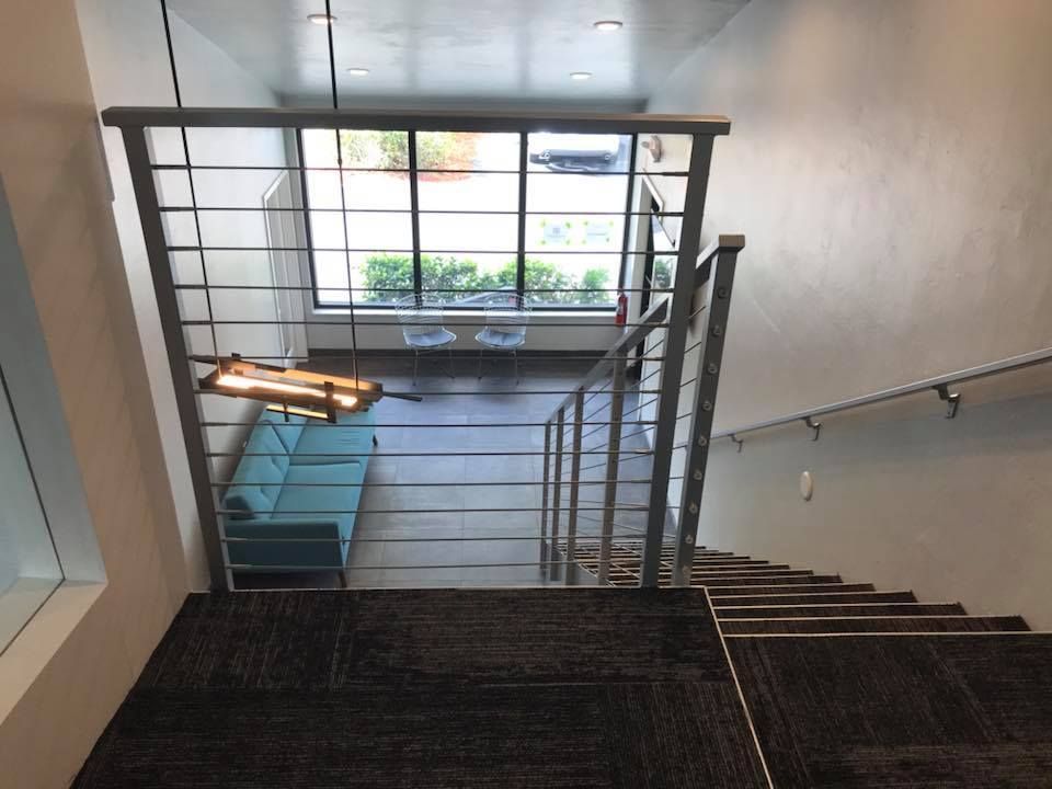 A staircase leading up to a living room with a blue couch