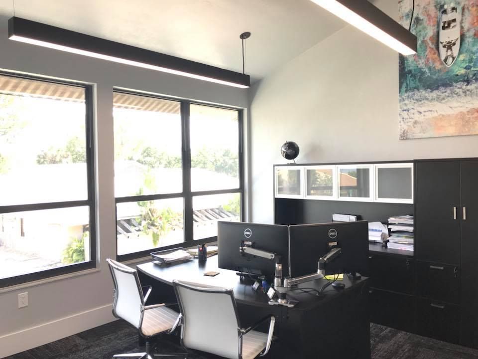 A office with two desks and two computer monitors.