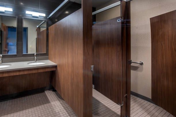 Clean and modern corporate bathroom with sleek fixtures and accessible design features.
