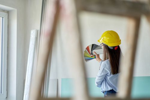 A woman is choosing the color to match the interior design.
