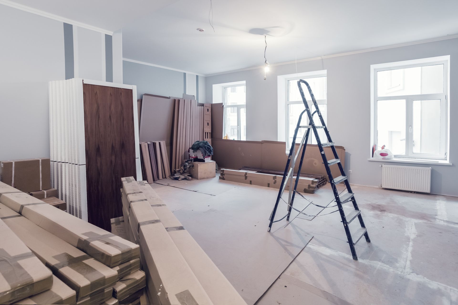 Interior of apartment with wooden planks and other materials, as well as stepladders. Interior of apartment with wooden planks and other materials, as well as stepladders.