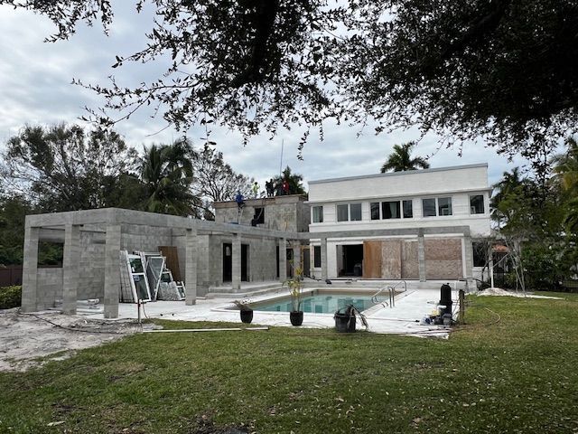 A brick building under construction with a palm tree in the background.