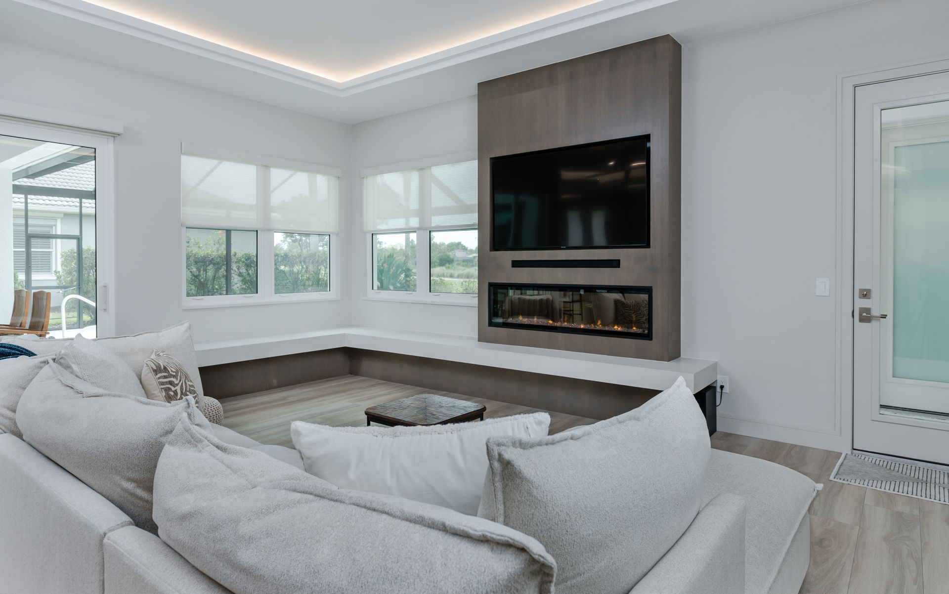 A living room with a couch , fireplace and television.