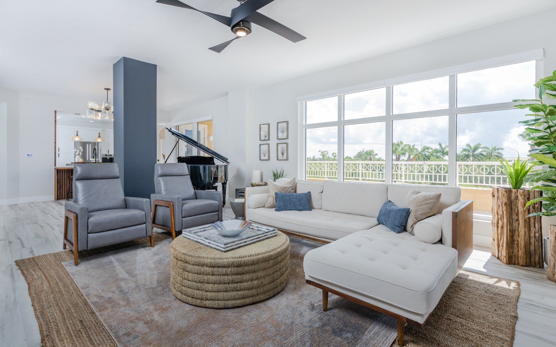 A living room filled with furniture and a ceiling fan.