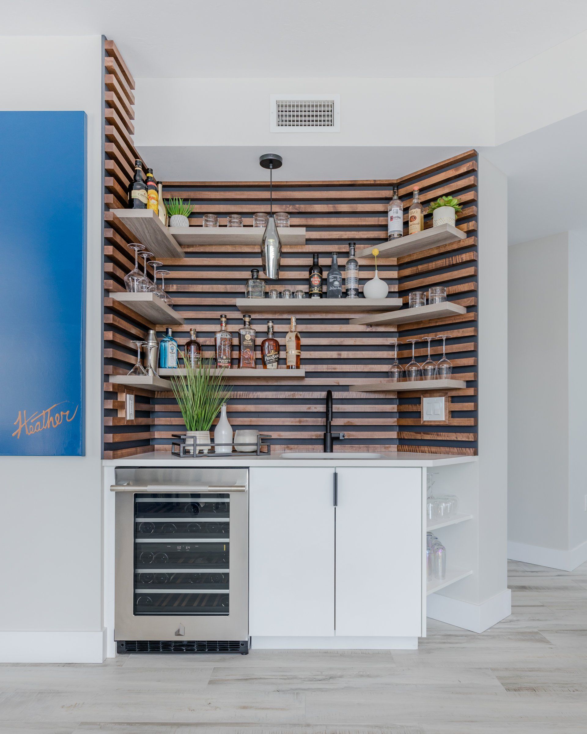 A kitchen with a bar and a refrigerator
