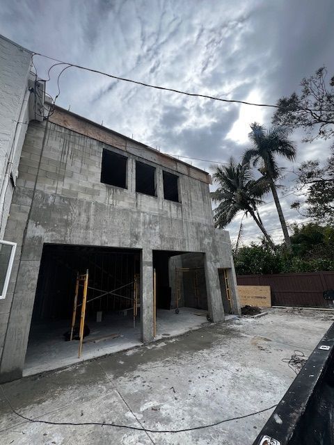 A building under construction with a truck parked in front of it.
