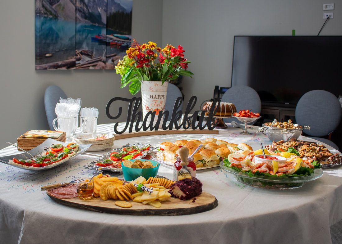 A table topped with plates of food and a thank you sign.