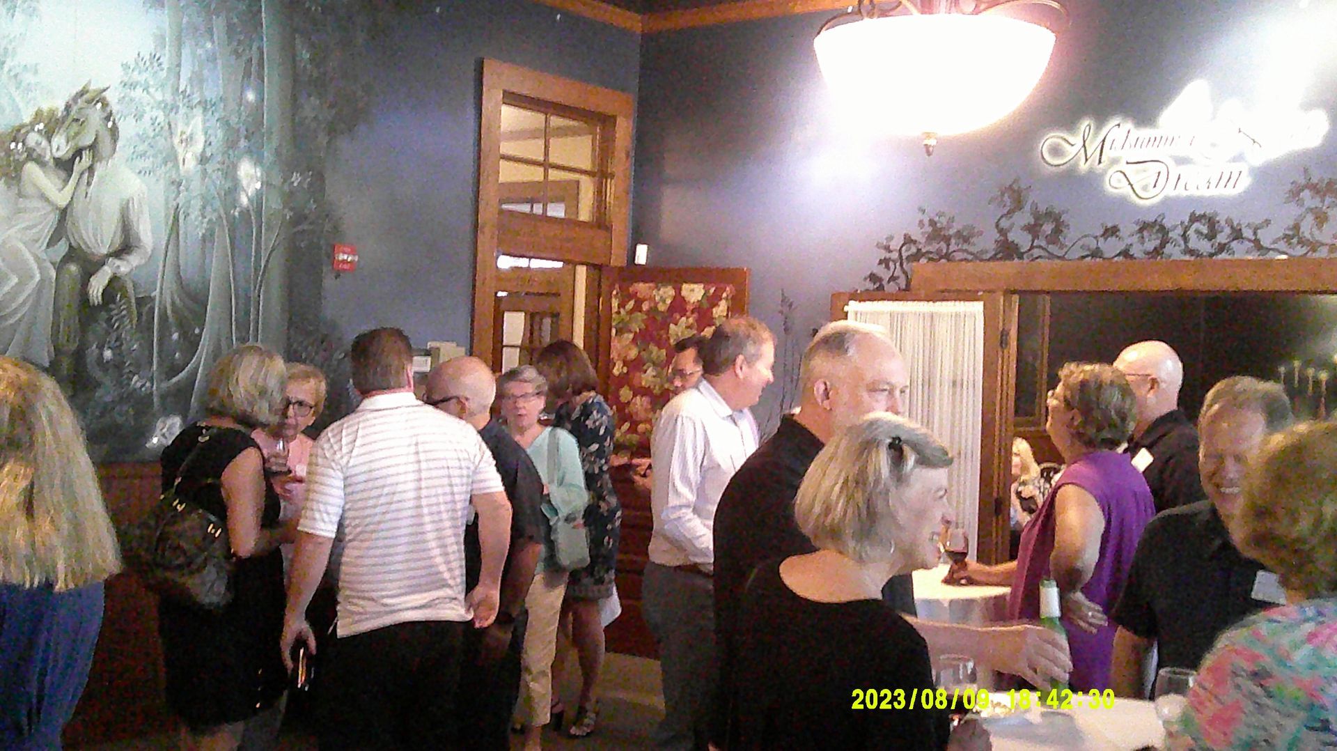 A group of people are standing around a table in a room.