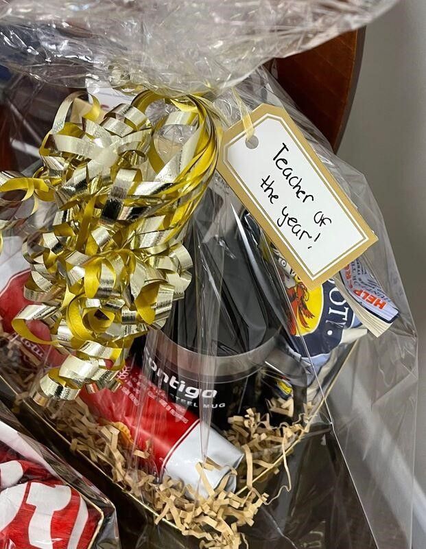 A gift basket with a tag that says teacher of the year