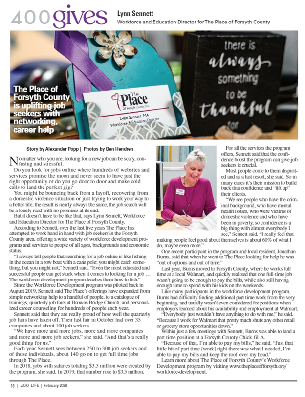A woman is sitting at a table in front of a sign that says `` there is always something to be thankful ''.