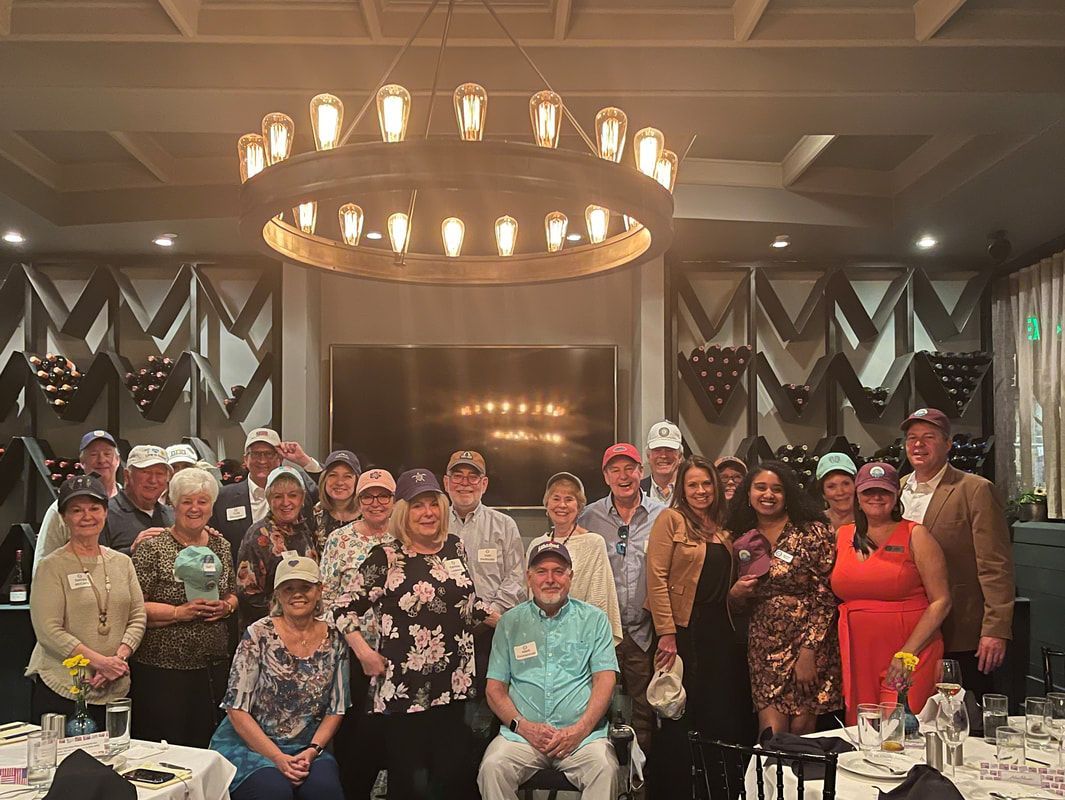 A group of people are posing for a picture in a restaurant.