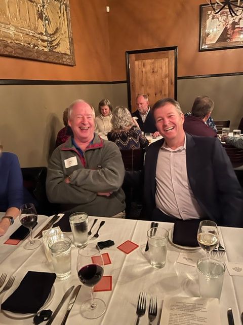 A group of people are sitting at a table in a restaurant