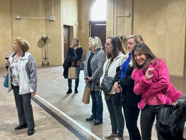 A group of women are standing next to each other in a room.