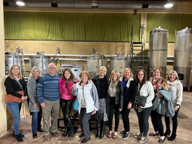 A group of people are posing for a picture in a factory.