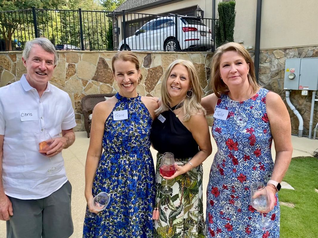 A group of people are posing for a picture in a backyard.