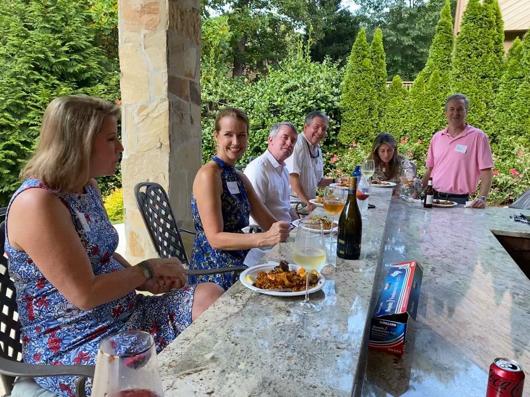 A group of people are sitting at a table eating food.