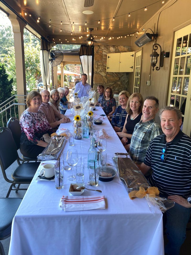 A group of people are sitting at a long table.