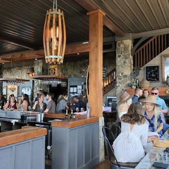 A group of people are sitting at tables in a restaurant.