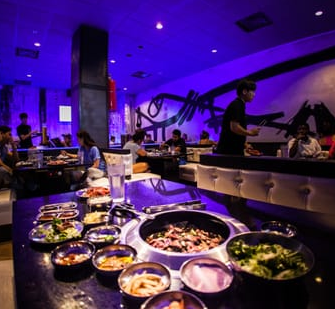 A restaurant with a lot of bowls of food on the table