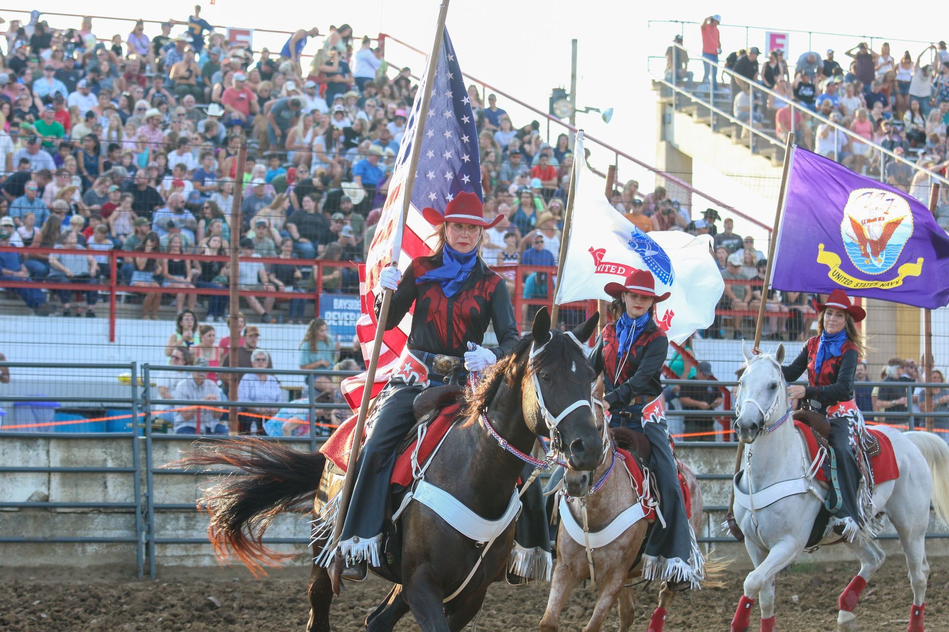 Riding horses with flags at the Dodge County Rodo