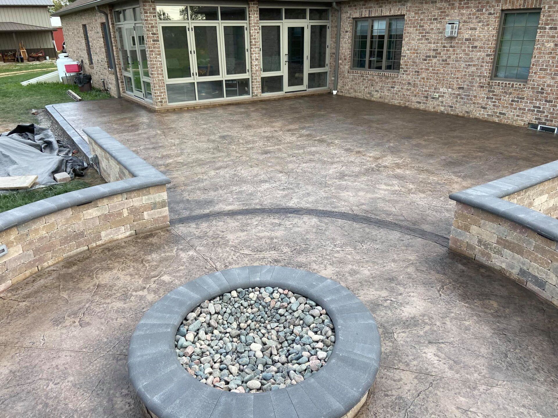There is a fire pit in the middle of the patio.