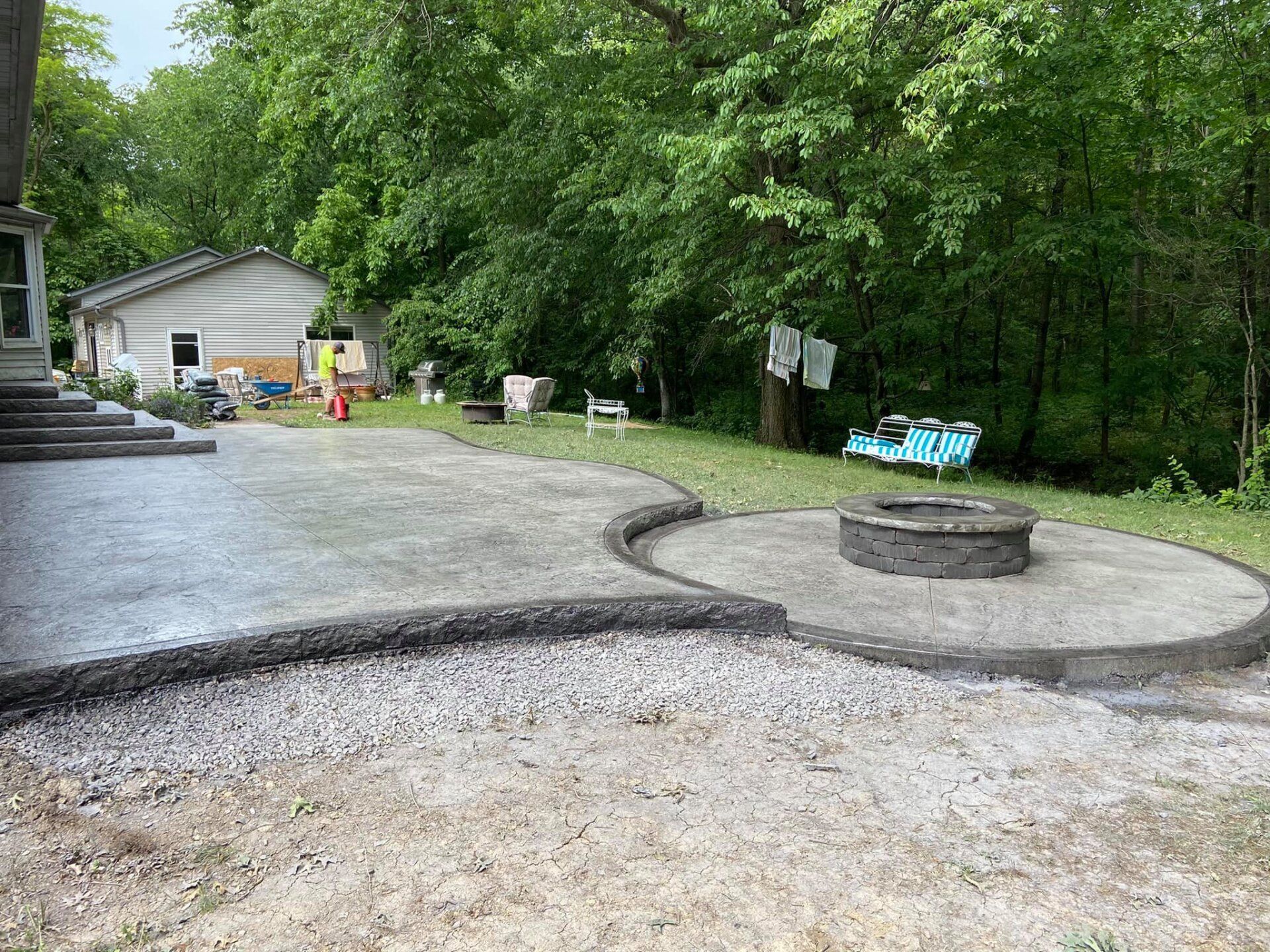 There is a fire pit in the middle of the patio.