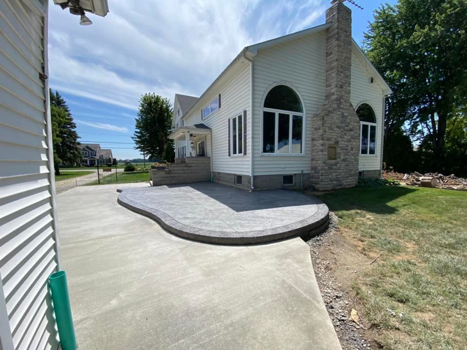 A large white house with a patio in front of it