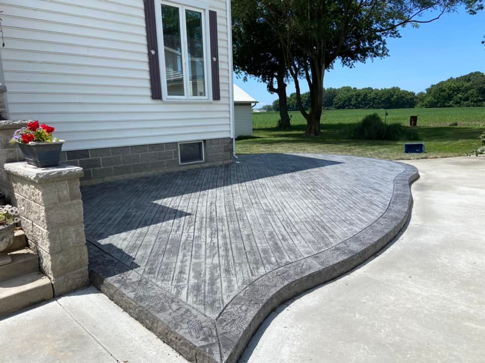 A white house with a curved concrete walkway in front of it