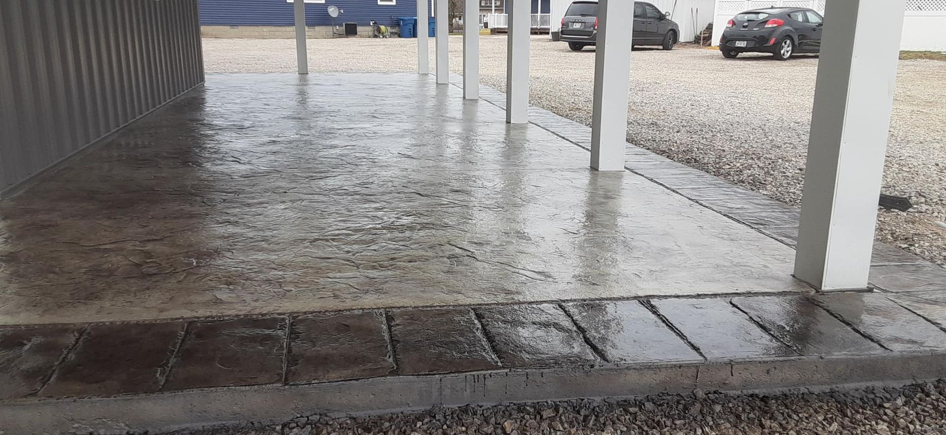 A parking lot with cars parked under a covered area.