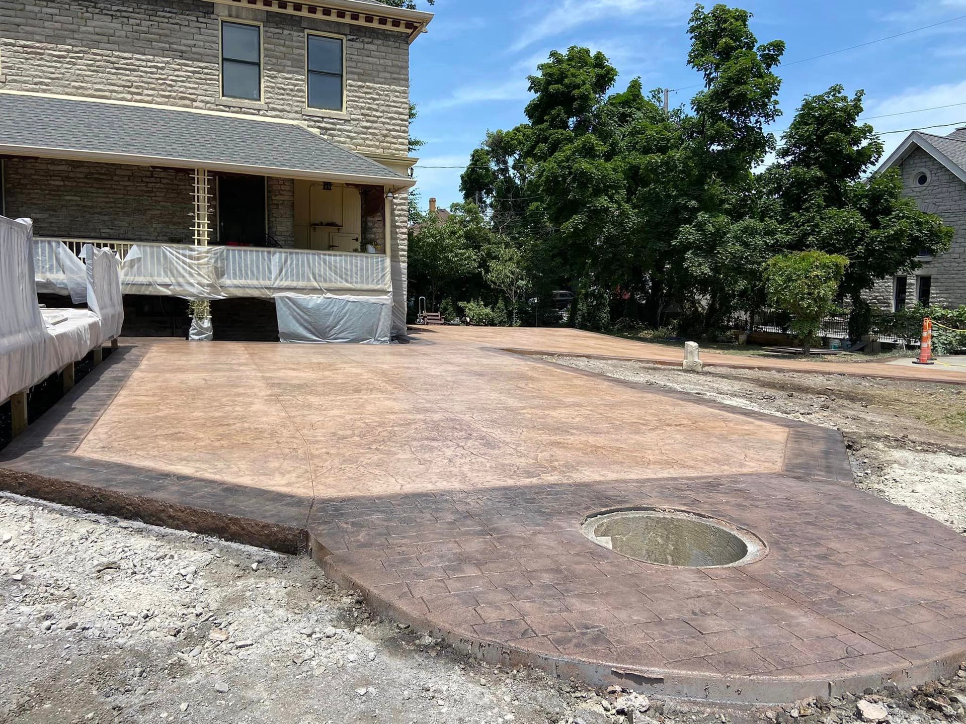A large house with a concrete driveway in front of it