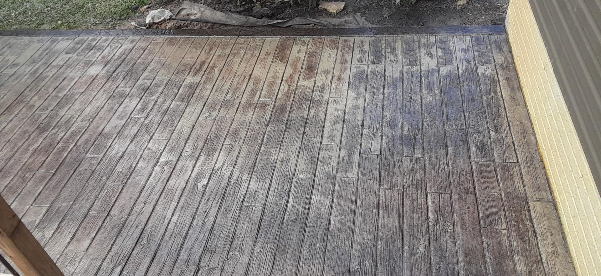 A close up of a wooden deck with a yellow border.