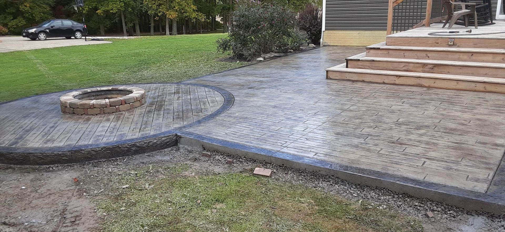 There is a fire pit in the middle of the patio.