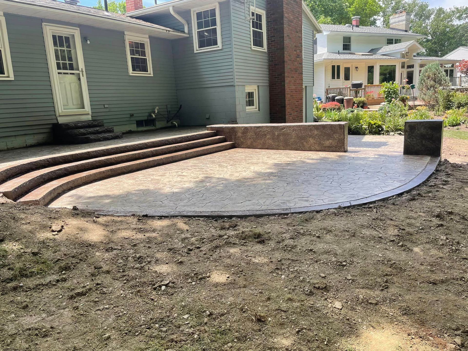 A house with a patio and stairs in front of it.