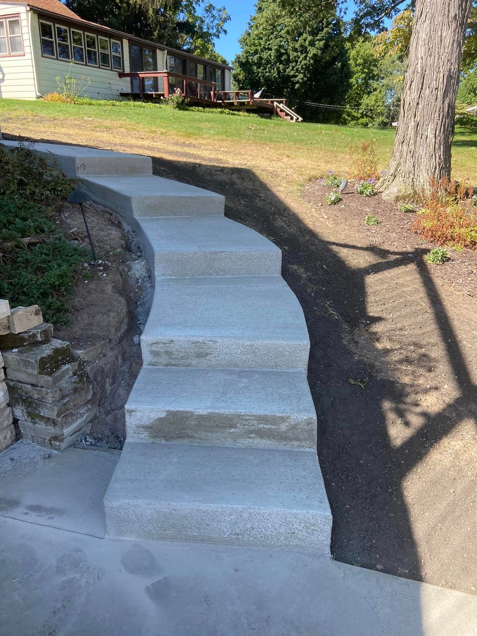 A set of concrete stairs leading up to a house.