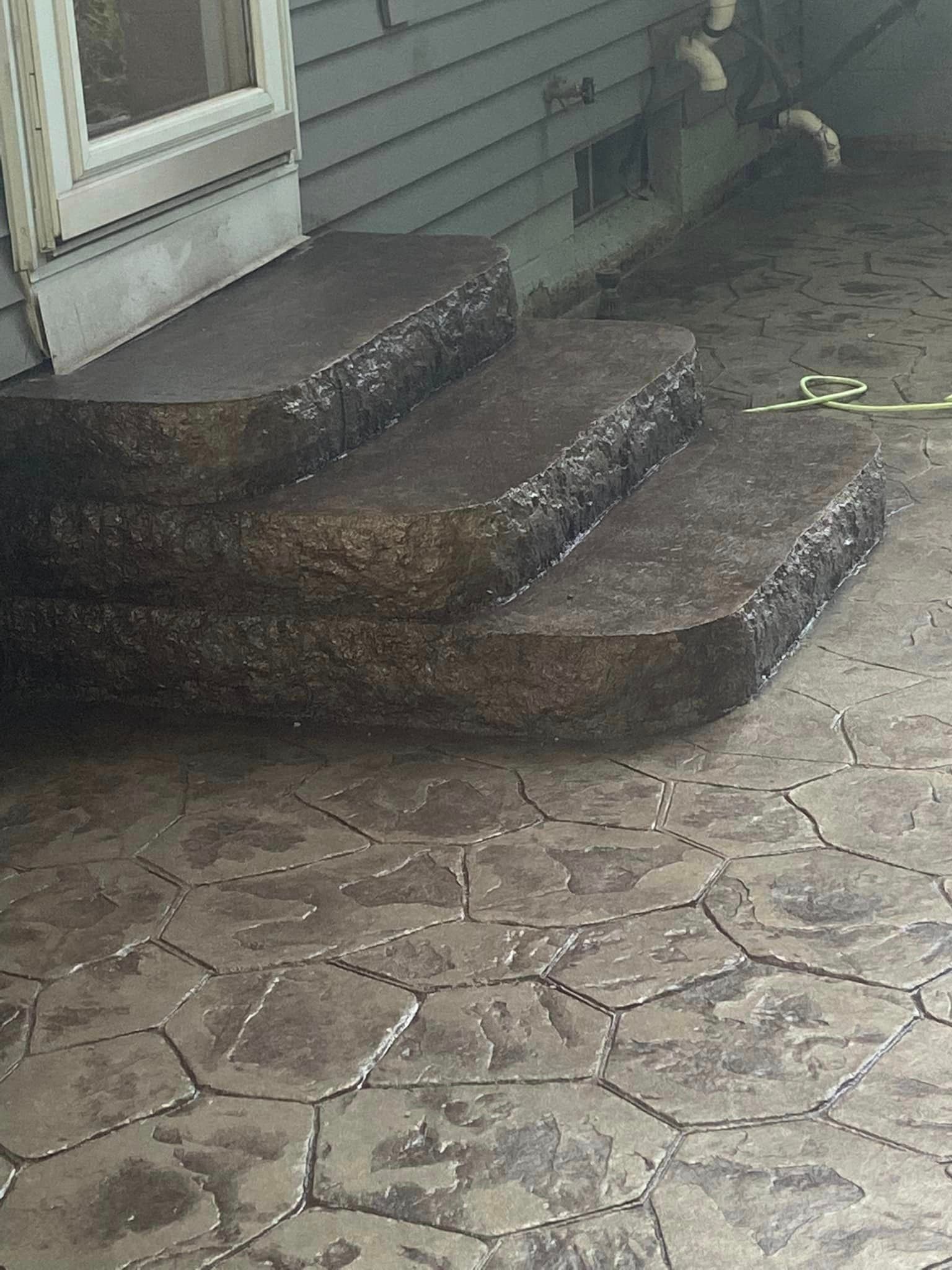 A set of concrete steps leading up to a house.