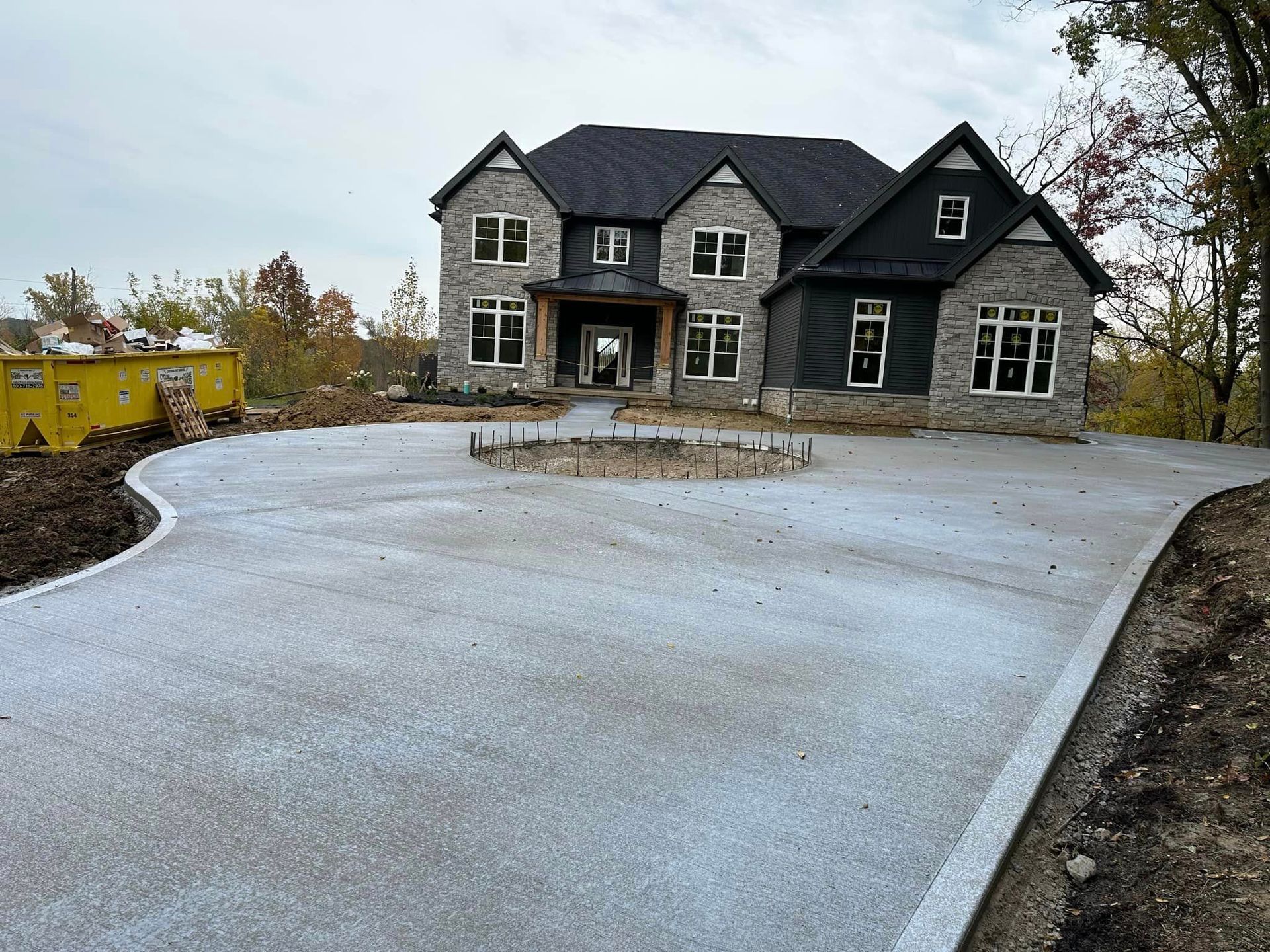 A large house with a concrete driveway in front of it.