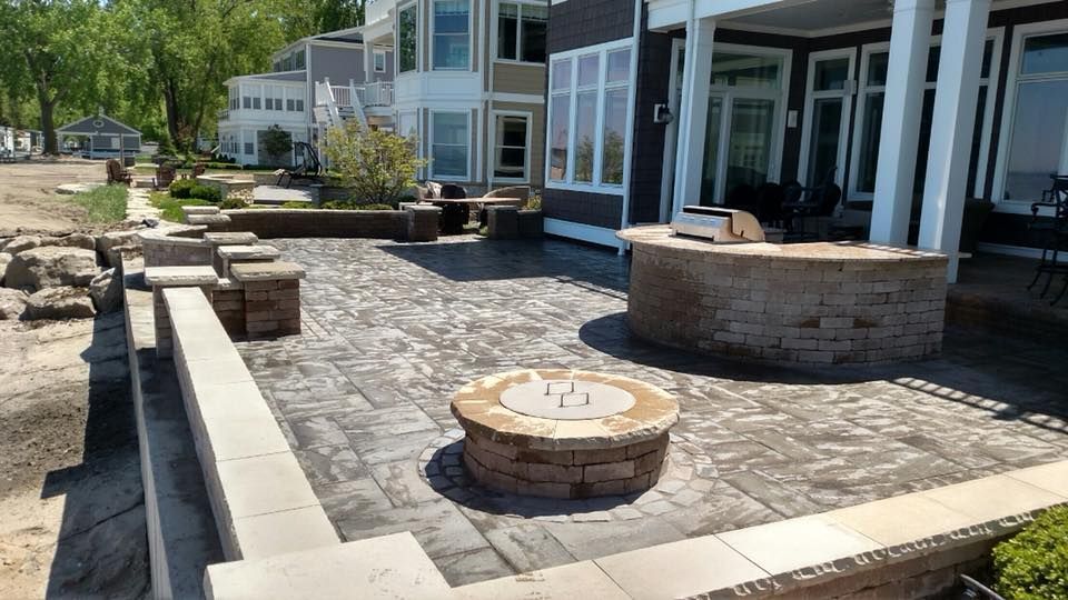 There is a fire pit in the middle of the patio.