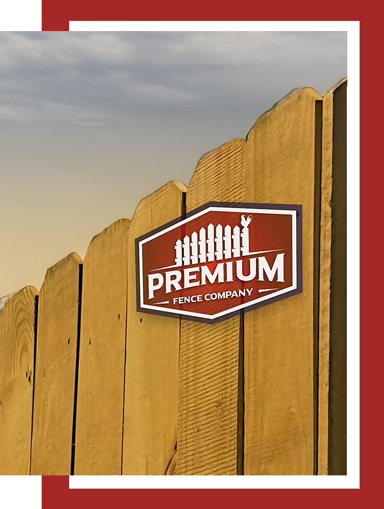 A wooden fence with a premium fence company sign on it.