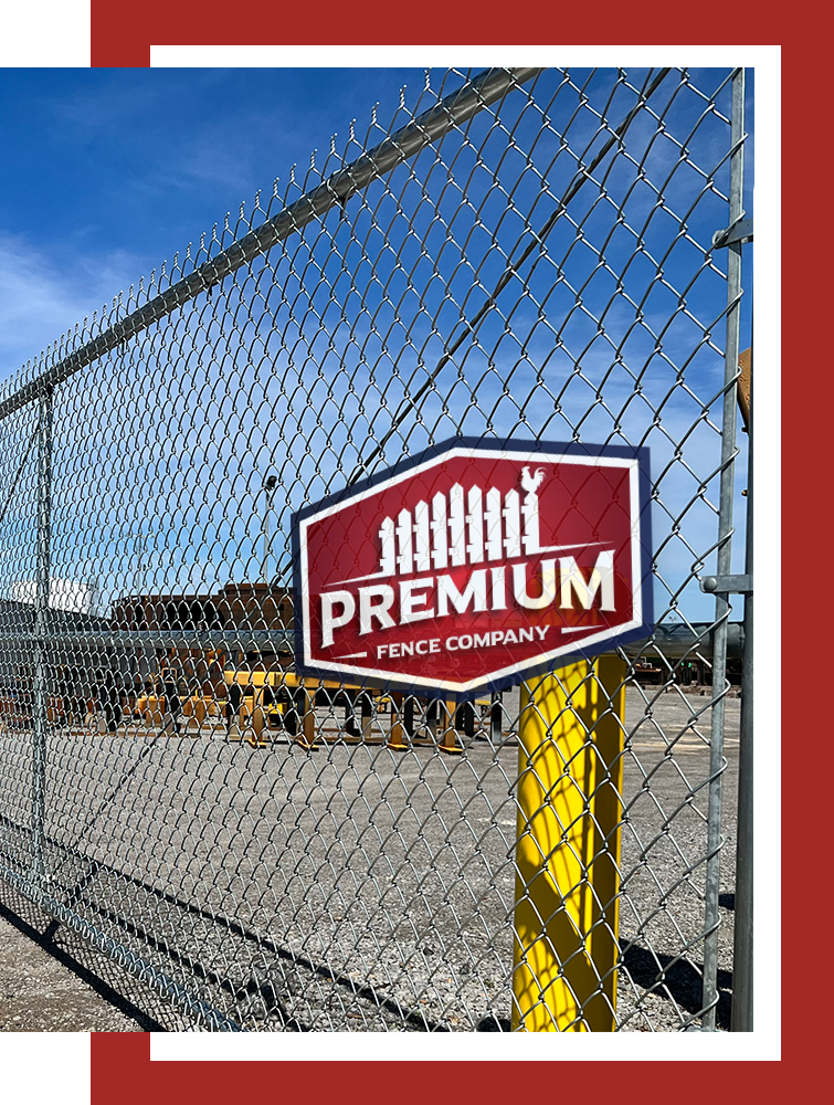 A chain link fence with a sign on it that says premium fence company.