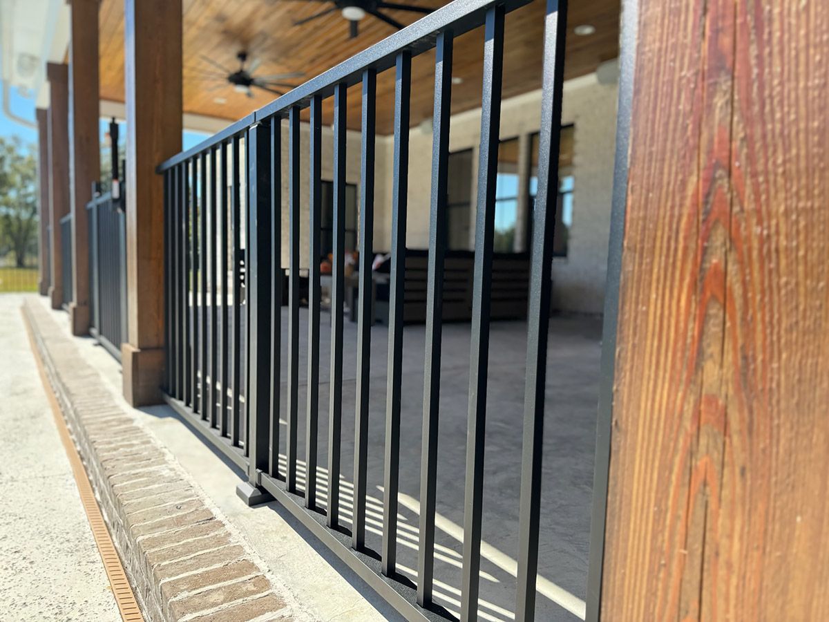 A close up of a black metal railing on a porch.