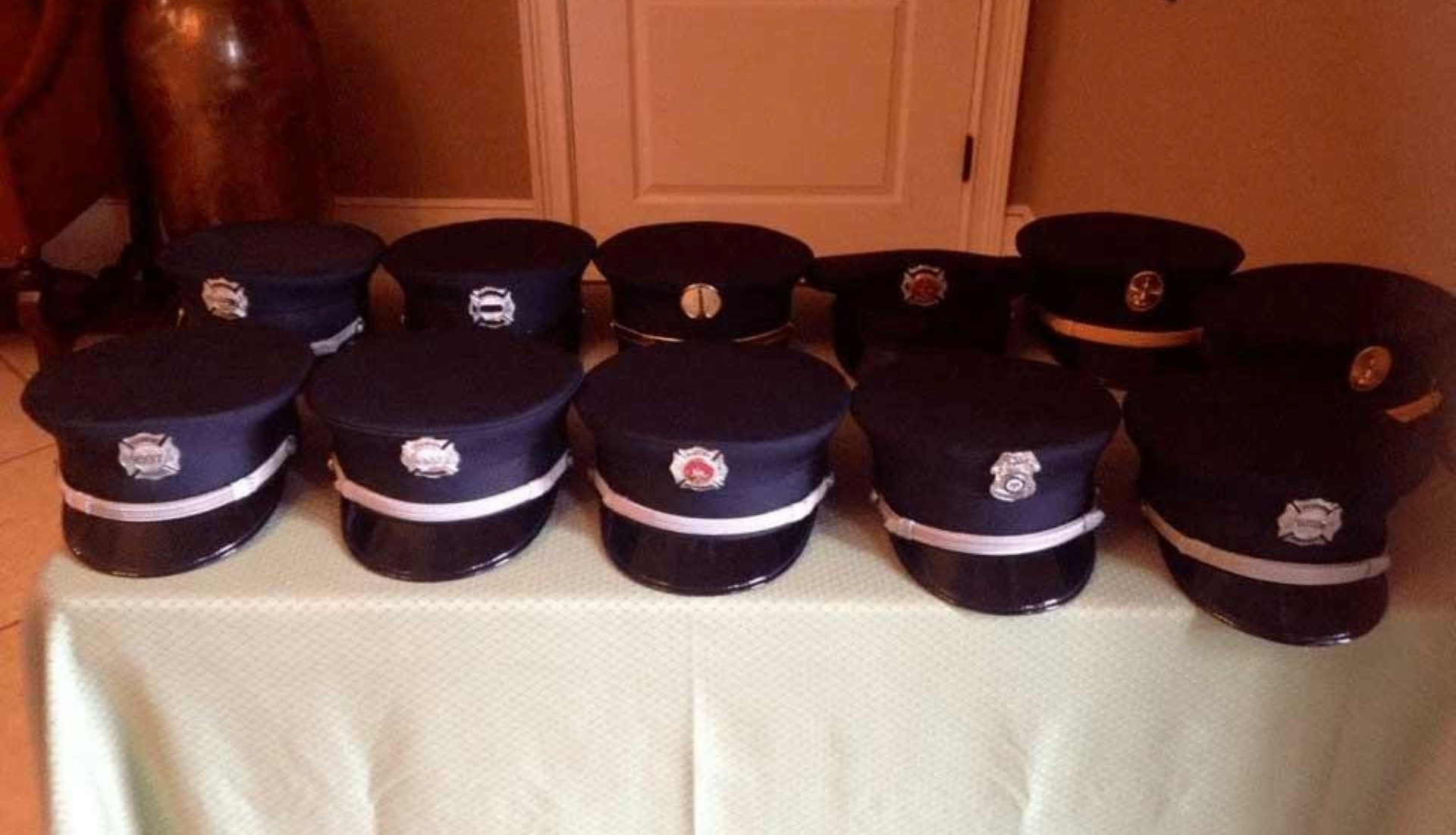 A woman is holding an american flag and a rose at a funeral.